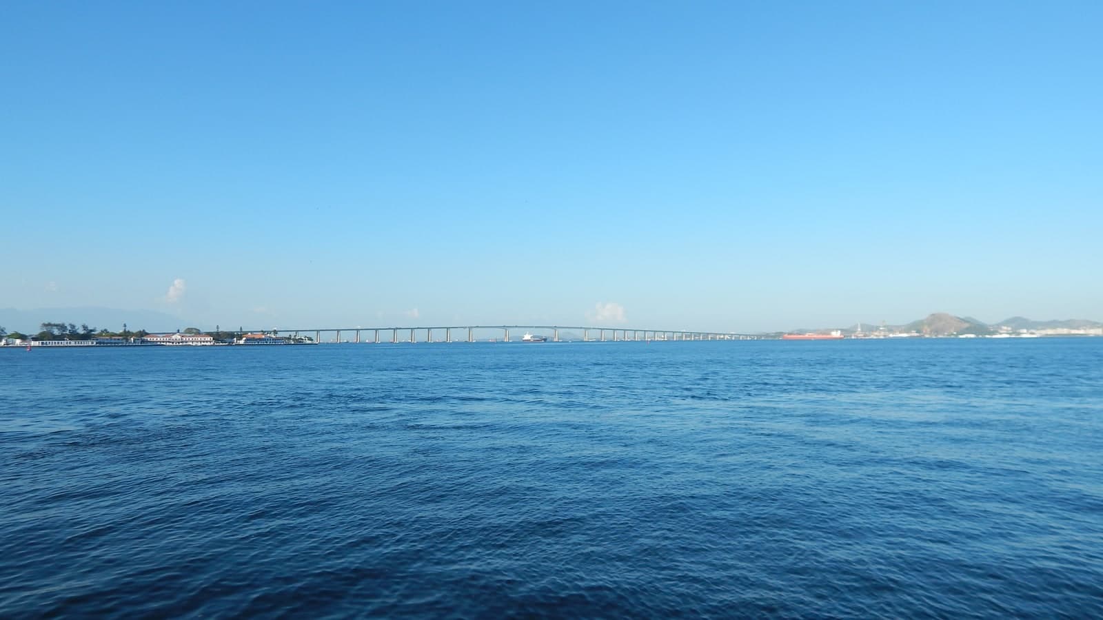 里约—尼泰罗伊大桥：从瓜纳巴拉湾水面斜看桥梁，桥墩、桥下净空与湾区关系清楚。